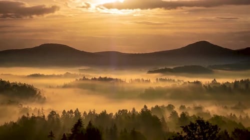 Sunset timelapse over mountain and trees with colorful clouds