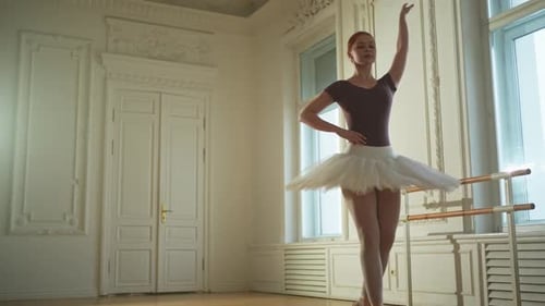 Ballerina Poses Gracefully in Bright Dance Studio