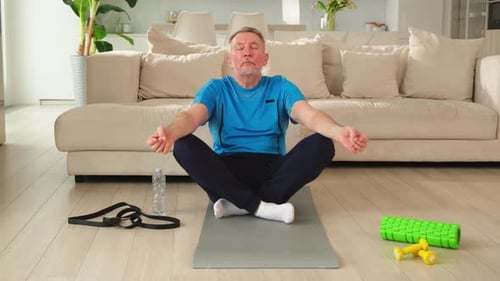 Senior Man Meditating on a Yoga Mat