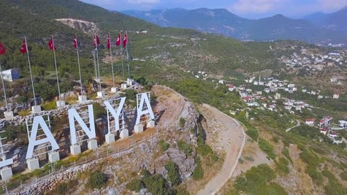 Alanya Sign with Turkish Flags Waving in the Wind