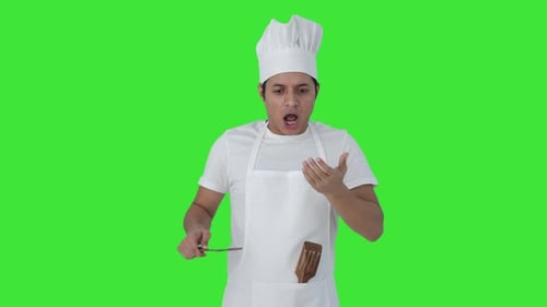 Indian professional chef tasting spicy food Green screen