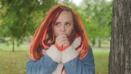 Woman with Colorful Hair in Park on a Cold Day