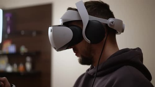 Man Uses Virtual Reality Headset at Home