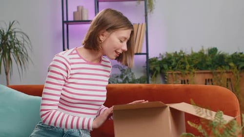 Woman Opens Box Smiling Thumbs Up