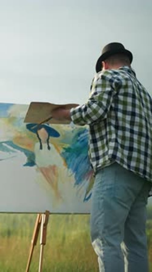 Artist Painting Woman in White Dress Posing in Tranquil Grassy Field