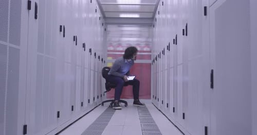 Young Adult with Tablet in Data Server Room