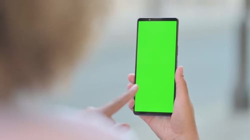 Close up of African Woman using Phone with Green Screen Outdoor