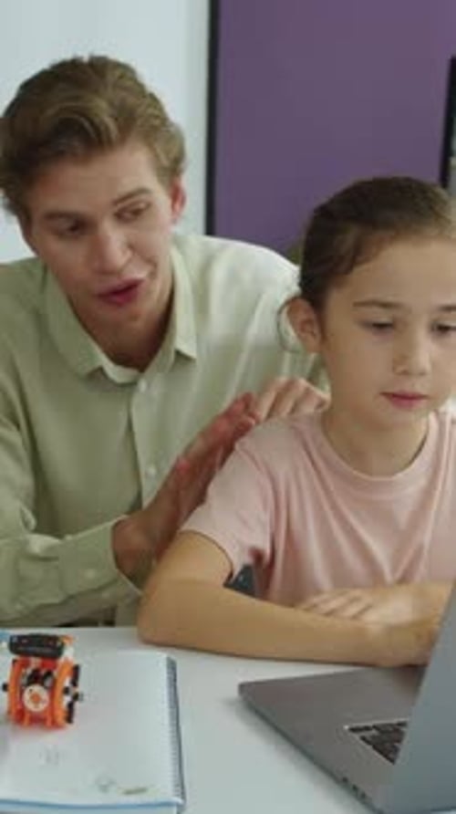 Child Learning on Laptop with Teacher