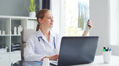 Doctor Works in the Medical Office Woman in White Coat Workplace of a Professional Female Therapist