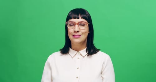4k footage of a young woman in studio making funny faces against a green background