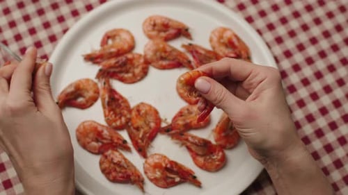 Hands Peeling a Cooked Shrimp Close Up