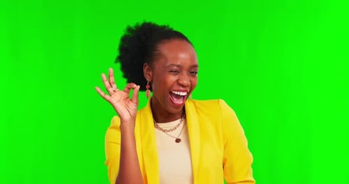 Perfect, hand and woman face with wink in green screen studio in support or agreement