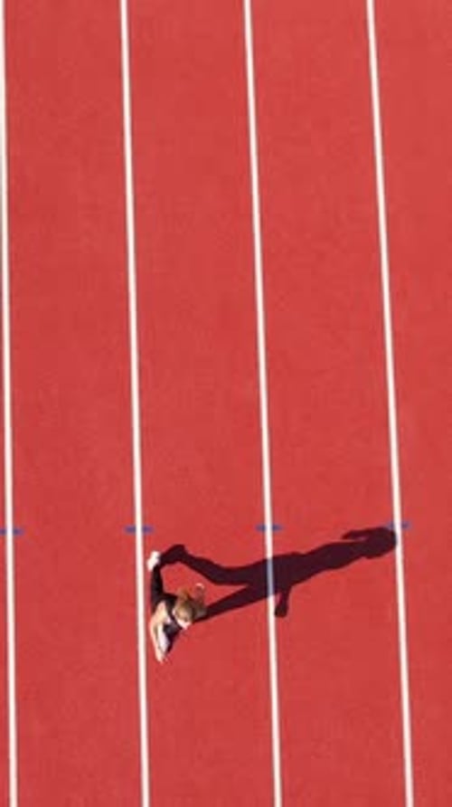 Woman Walking on Red Running Track from Above