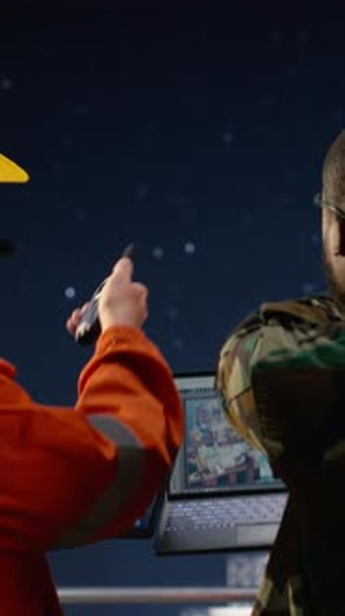 Vertical Video Drilling Ship Worker and Military Man Use Laptop to Monitor Threats During War