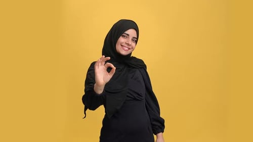 Beautiful Arabic Young Woman Black Hijab Showing Ok Okay Good Gesture Posing Isolated Orange Studio