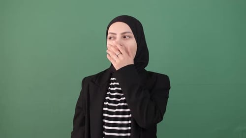 Young Woman Wearing Hijab Yawns