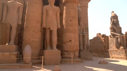 Sculptures of pharaohs inside the Luxor Temple and the drawings on the Egyptian columns in the city