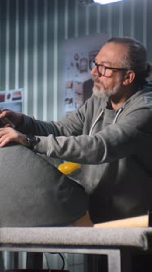 Man Building Gray Chair in a Workshop