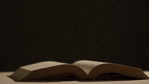 Open Book With Dust Particles in Dim Lighting