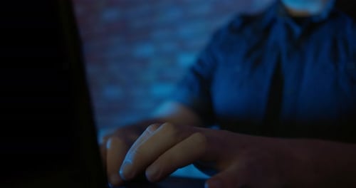 Man Using A Laptop Computer In A Dark Room