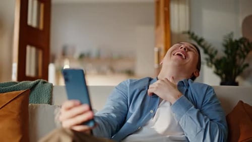 Man Laughing and Talking on a Video Call