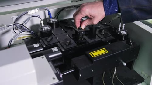 Man's hand takes out a part of medical equipment.