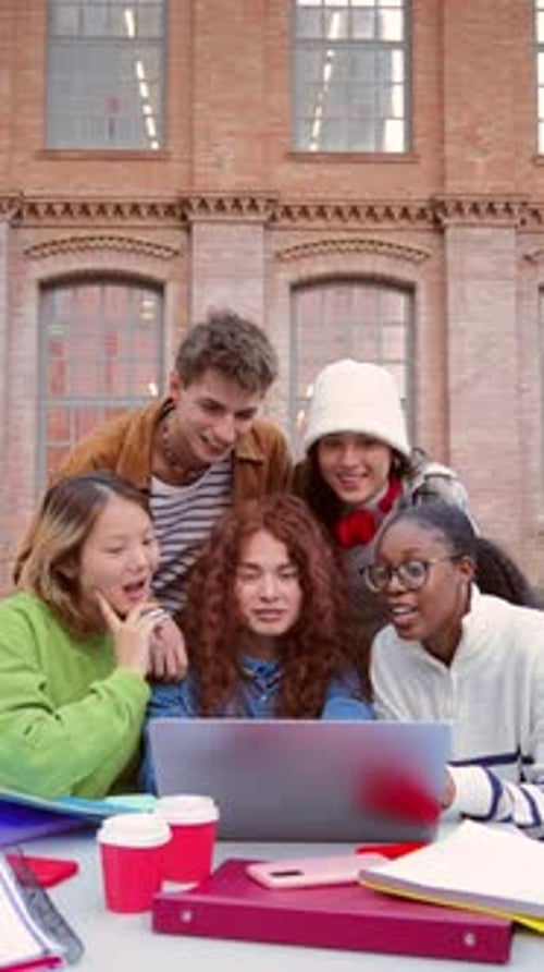 Vertical Diverse Group of Cheerful Teenage Students is Huddled Together in the University Campus