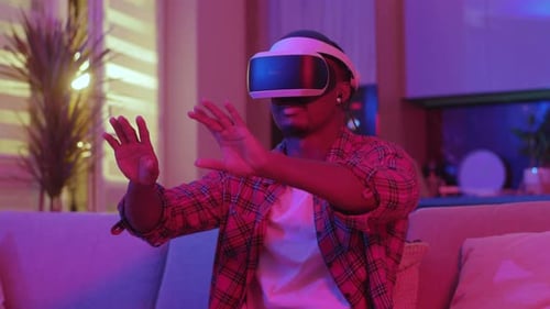 Man Wearing VR Headset Interacting with Virtual Reality