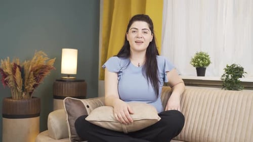 Woman Sitting on Couch Clapping Hands