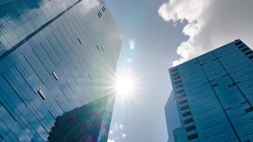 Time Lapse of Clouds Reflecting Into the Glass of a Large Office Building
