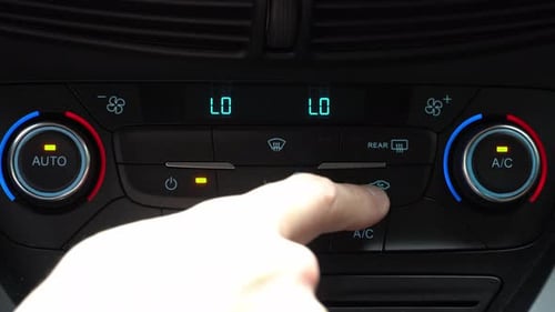 Finger presses button for turn off air recirculation mode in passenger compartment, two-phase