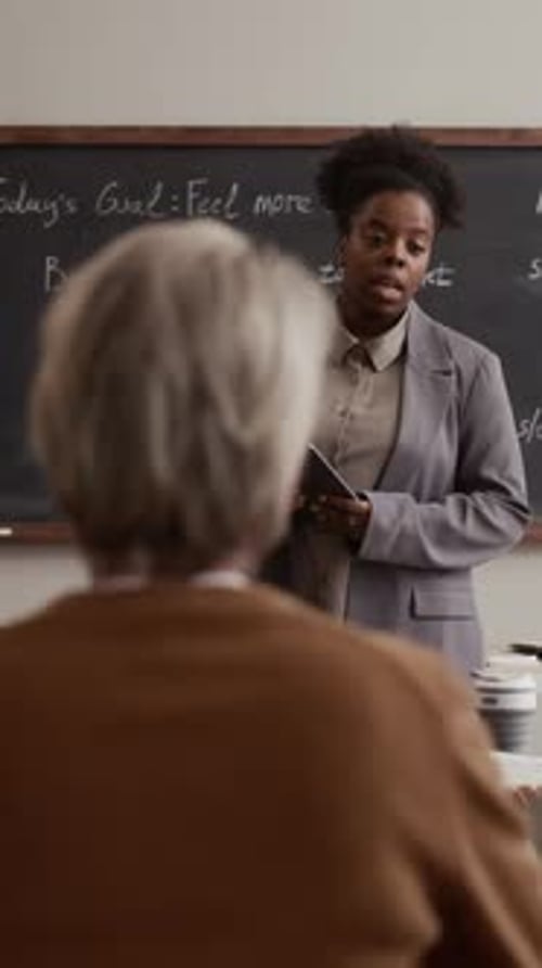 Teacher Lectures Students About Computer Program Functions in Classroom