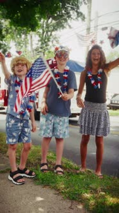 Family Celebrating with Flags on Sunny Sidewalk