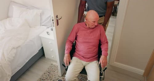 Assisted Living, Man in Wheelchair Being Pushed