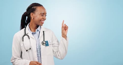 Happy black woman, doctor and pointing in marketing or advertising against a blue studio background