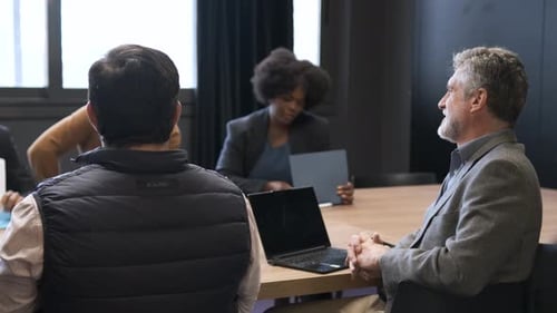 Happy Manager Listening to Presentation Given By Employees in Creative Office