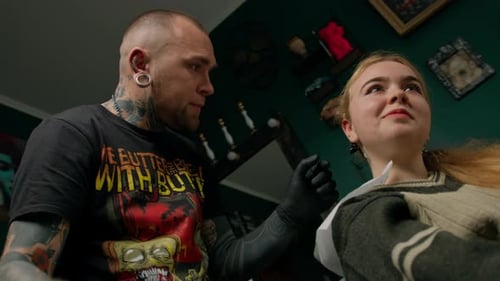 Piercing studio interior - piercing master makes a piercing to a girl, ear piercing