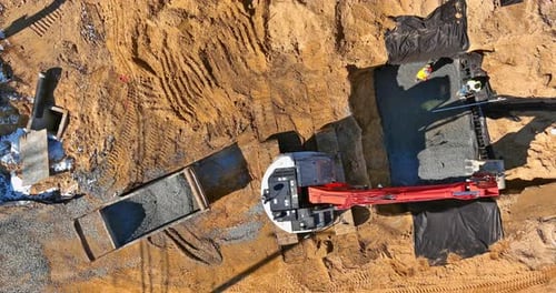 Excavator Moving Gravel in Urban Construction Site