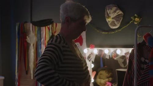 Adult Puts on Striped Shirt in Dressing Room