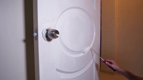 Man Paints Wooden Door White 2K