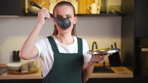 Woman Posing with Ladle in Home Kitchen