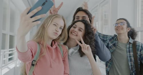 Friends Taking Selfie in School Hallway