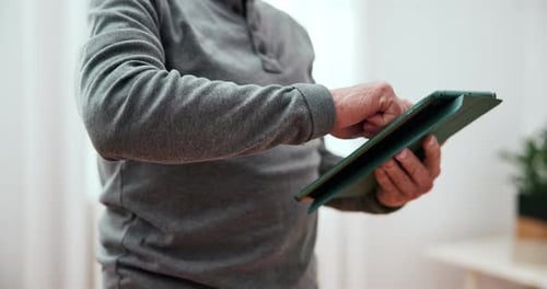 Senior Adult Using Tablet Indoors