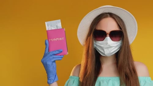 Young Woman with Mask Holding Passport and Ticket