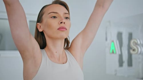 Woman Raising Arms in Fitness Workout in Home