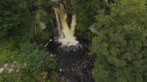 Aerial View of Waterfall in Lush Green Forest