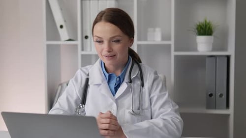 Friendly Woman Doctor Engaged in Telemedicine Consultation