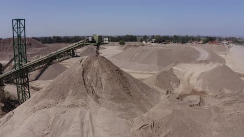 A large truck loaded with sand is heading towards the construction site, aerial shots of the truck a