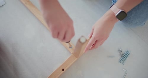 Carpenter Tightening Screw on Wooden Piece