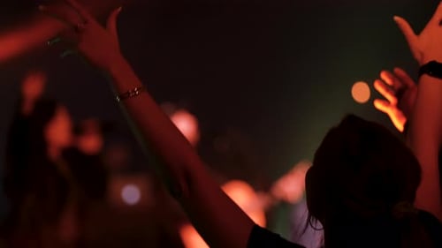 People lifting their hands in worship at a church.